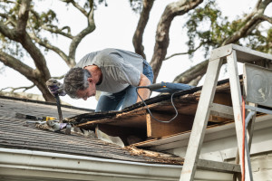 a man trying roof repair in Johnson County