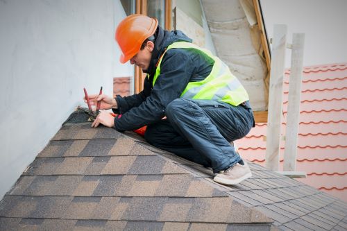 man measuring pitch of roof
