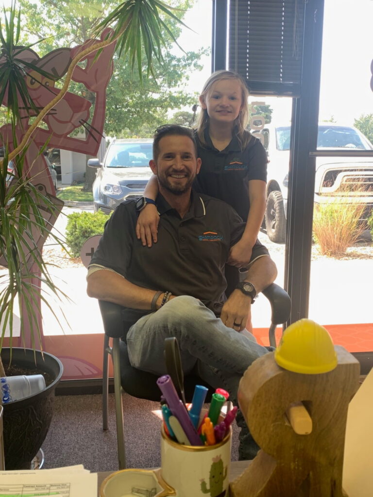 Garen Armstrong, executive director of Shamrock Roofing & Construction, and his daughter Abby.
