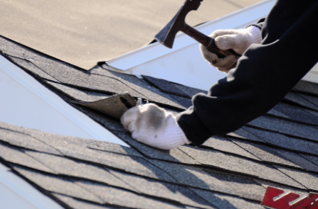 roofer nailing on shingle